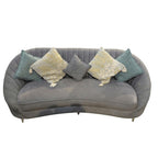 Homecrest Calvert sofa in grey velvet with a curved back, featuring decorative throw pillows in blue and cream.