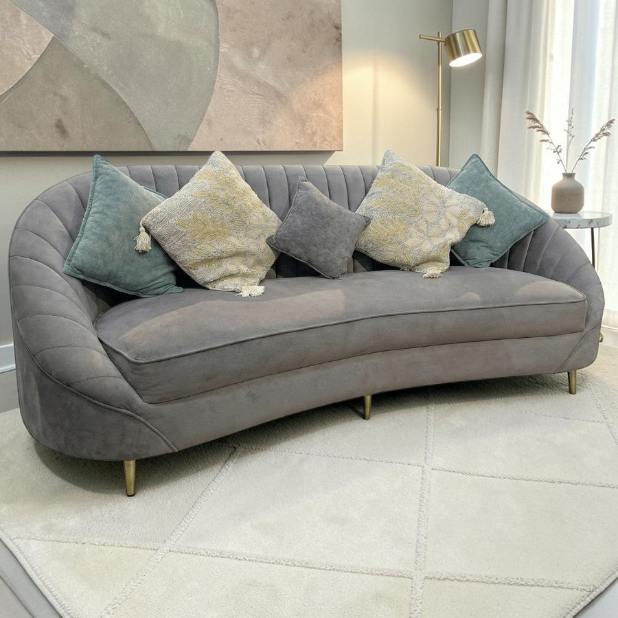 Homecrest Calvert sofa in grey velvet with curved back, solid wood frame, and decorative throw pillows.