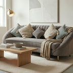 Homecrest Calvert sofa in grey velvet with curved backrest, decorative throw pillows, and a light beige throw blanket.