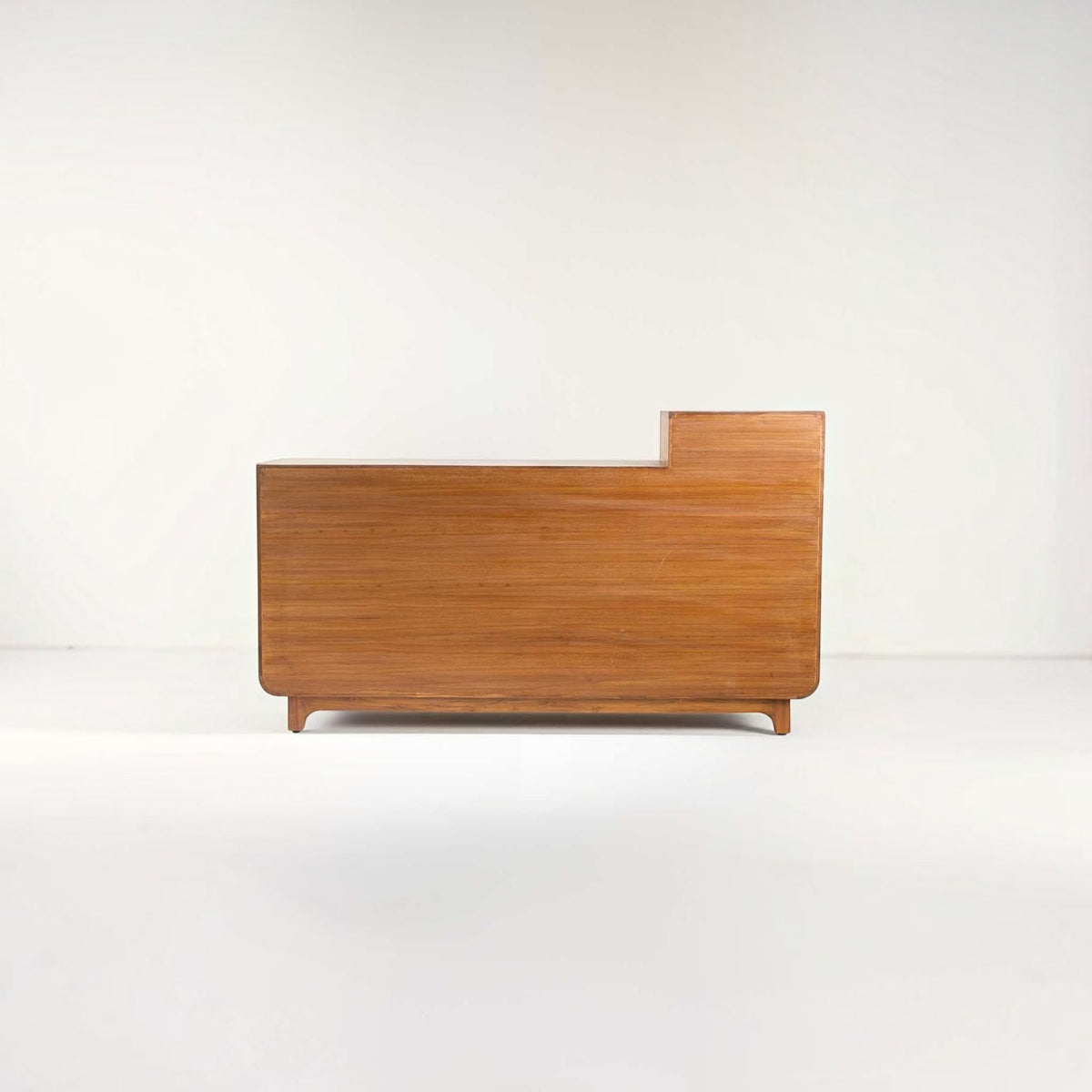 Homecrest Selby sideboard in medium teak wood with a stepped silhouette and smooth finish against a white background