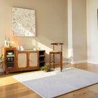 Homecrest Selby sideboard in medium teak with wicker doors, fluted glass cabinet, and open shelving in a living room.