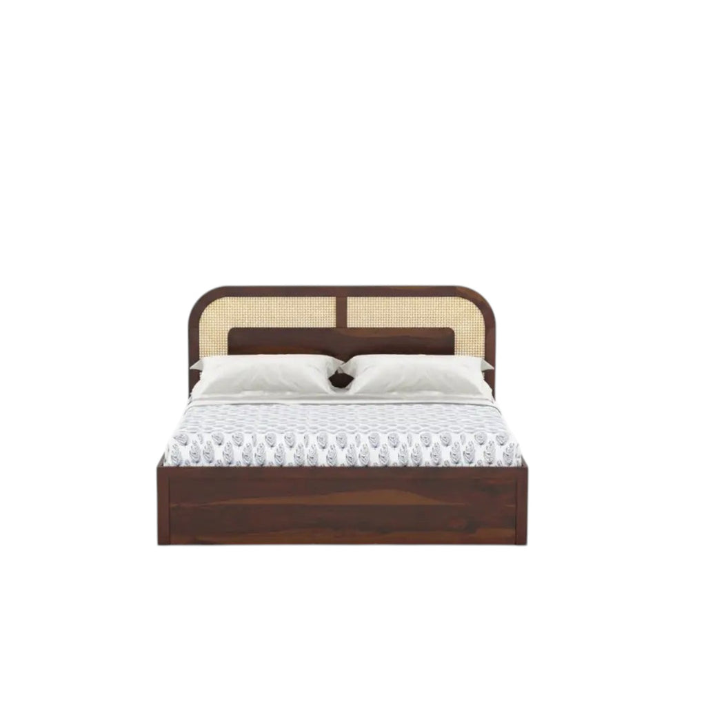 Homecrest Rhodin Sheesham wood bed with a walnut finish, cane headboard detailing, and integrated hydraulic storage.