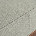 Close-up of Homecrest 2-seater sofa showing the textured light green fabric upholstery and piped cushion edges.
