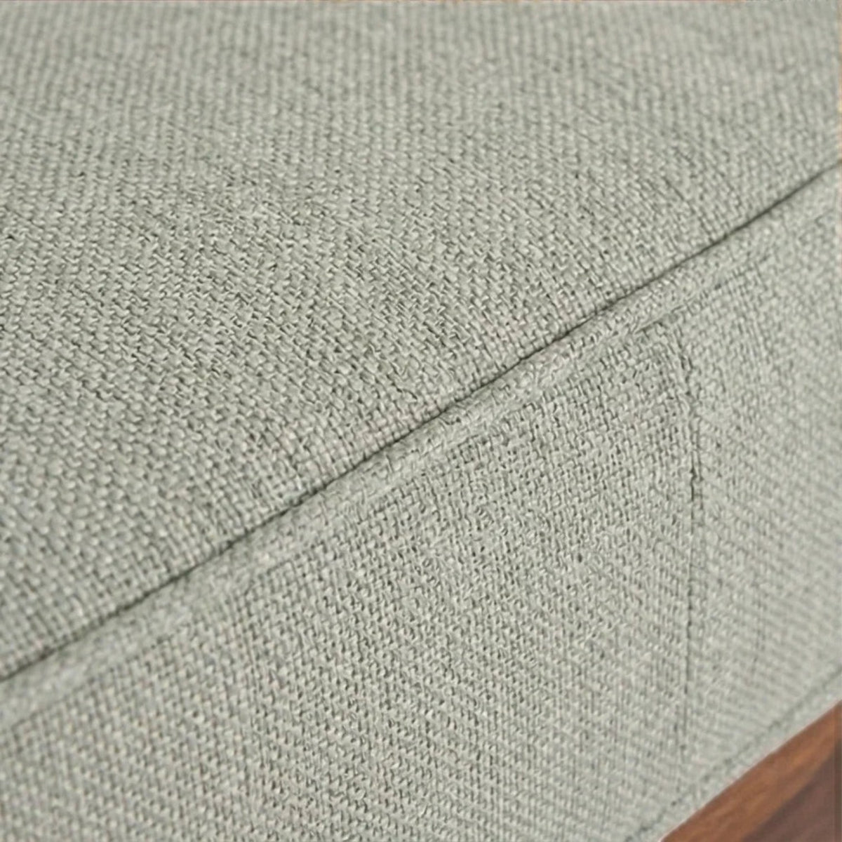 Close-up of Homecrest 2-seater sofa showing the textured light green fabric upholstery and piped cushion edges.