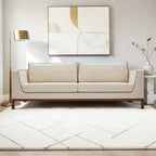 Homecrest Solace deep-seat lounge sofa in ivory fabric with contrast piping on a teakwood base in a modern living room.