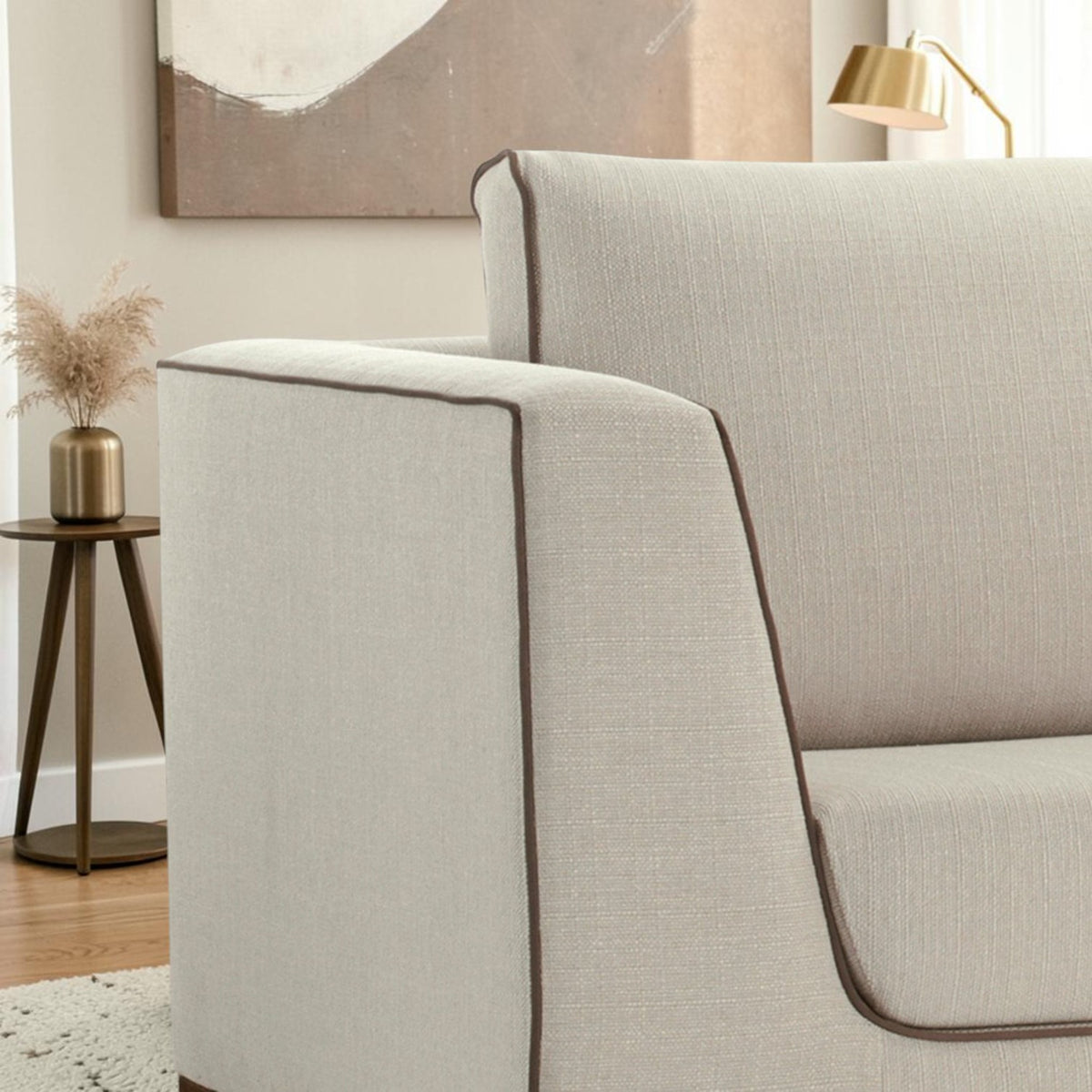 Homecrest Solace deep-seat lounge sofa in ivory fabric with brown contrast piping on a teakwood base
