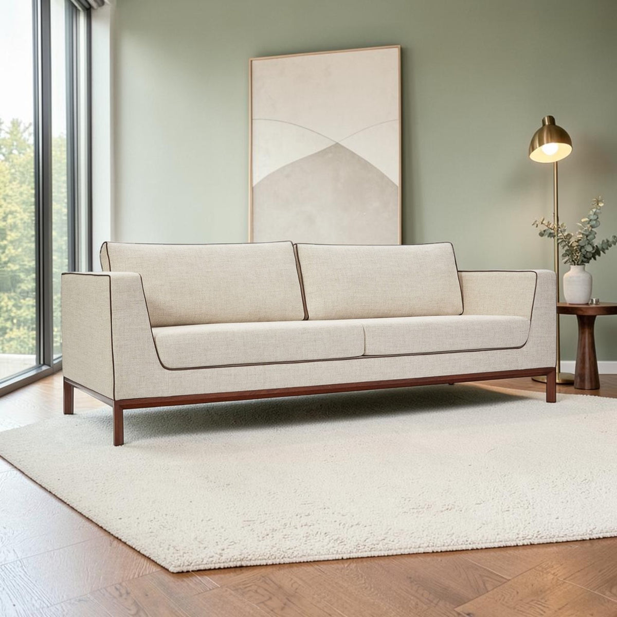 Homecrest Solace deep-seat lounge sofa in ivory fabric with brown contrast piping on a solid teakwood base frame.