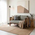 Homecrest 2-seater sofa with solid wood frame, natural cane side panels, and sage green fabric cushions in a living room