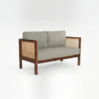 Homecrest 2-seater sofa with a rich walnut solid wood frame, natural cane side panels, and grey fabric cushions.