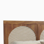 Homecrest solid wood bed frame featuring a triple arch headboard with intricate handwoven natural rattan cane panels.