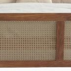 Homecrest solid wood bed frame featuring intricate handwoven rattan cane detailing on the footboard