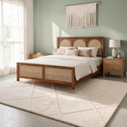 Homecrest solid wood bed frame featuring a triple arch rattan headboard and matching cane footboard in a bedroom.