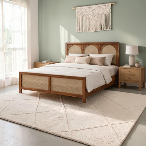 Homecrest solid wood bed frame featuring a triple arch rattan headboard and matching cane footboard in a bedroom.