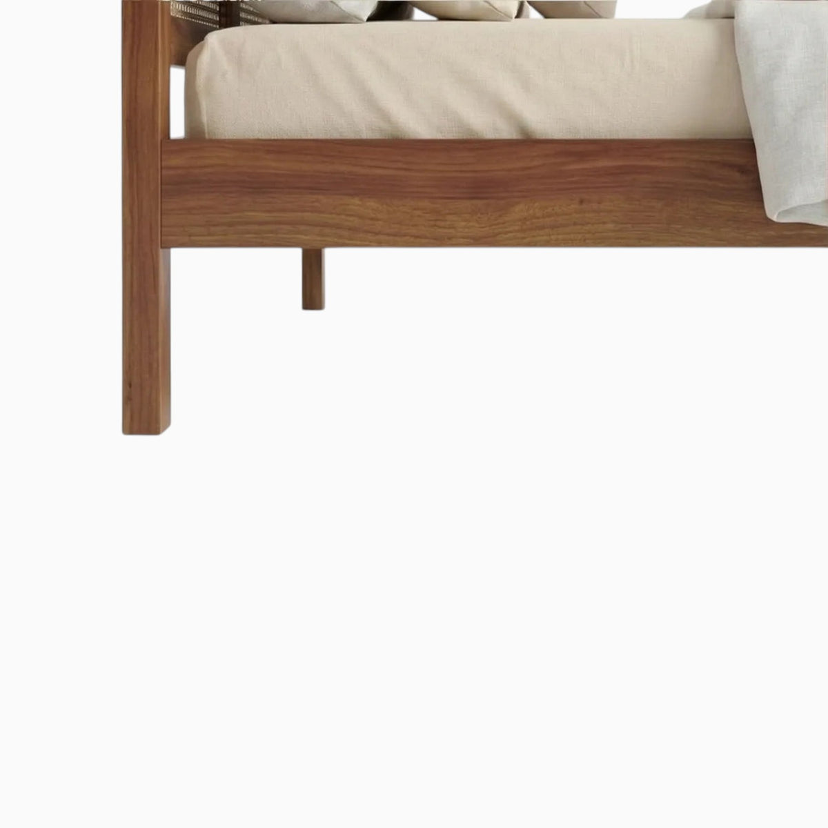 Homecrest solid wood bed frame with natural rattan cane detailing and warm wood finish, close-up view of footboard.