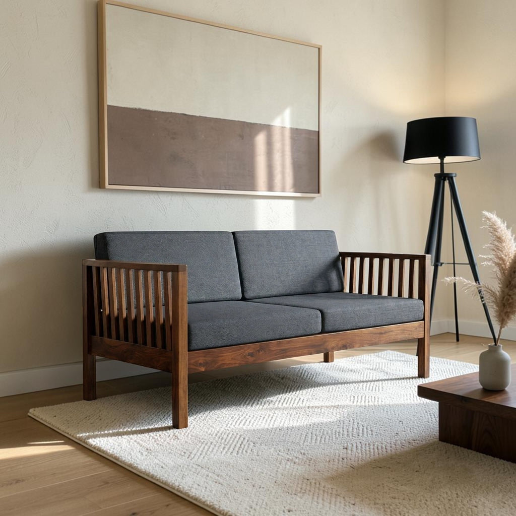 Homecrest contemporary solid wood sofa with dark grey cushions and slatted armrests in a modern living room setting.