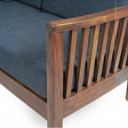 Homecrest contemporary sofa with rich walnut finish solid wood frame and dark grey fabric cushions with slatted arms
