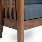 Homecrest contemporary sofa featuring a rich walnut finish solid wood frame with elegant vertical slatted armrests.