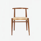 Homecrest Thornby dining chair featuring a natural teak wood frame and a hand-woven rattan wicker seat in a coastal style
