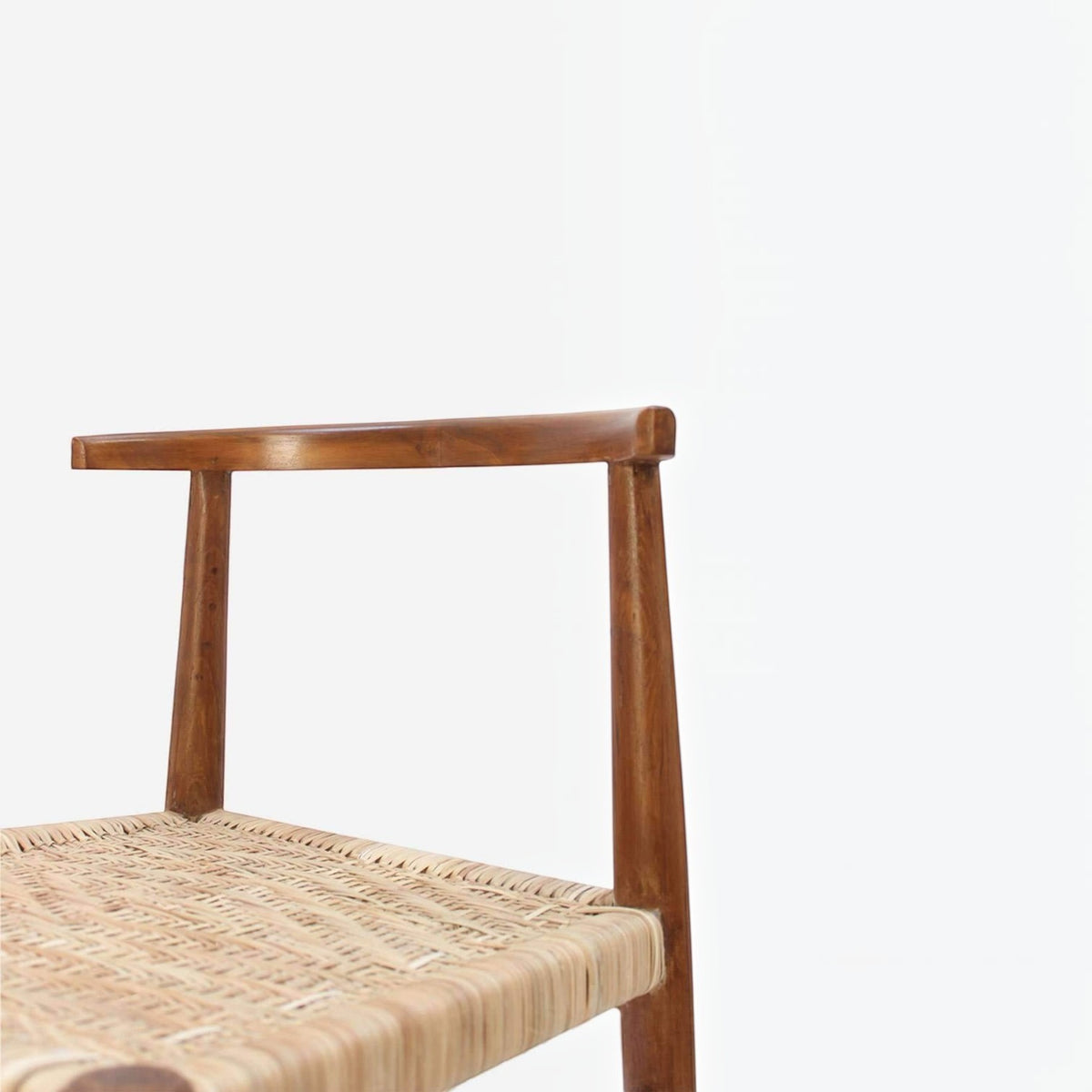 Homecrest Thornby dining chair featuring a hand-shaped teak wood frame and a natural hand-woven rattan wicker seat.