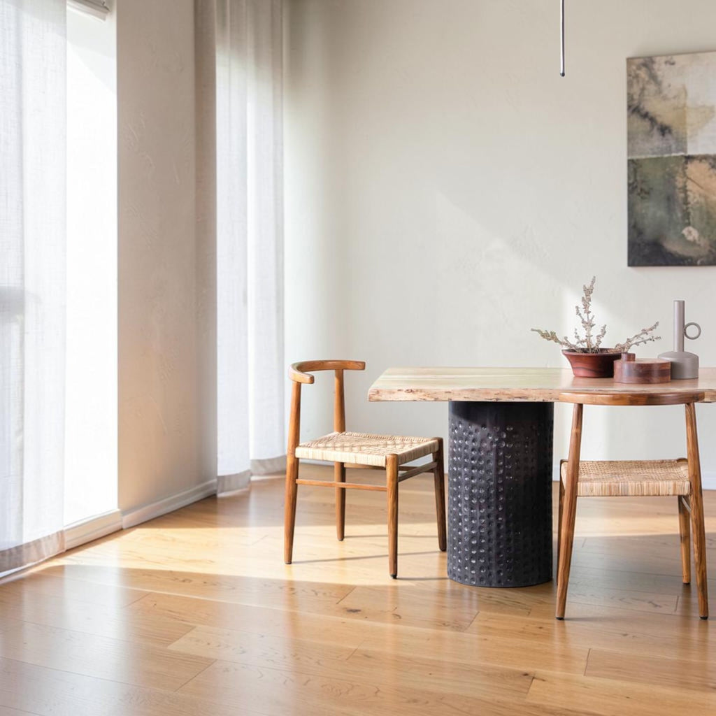 Homecrest Thornby dining chairs with teak wood frames and hand-woven rattan wicker seats in a bright coastal dining room
