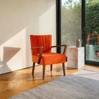 Homecrest Pelham armchair in vibrant orange fabric with a mid-century teak wood frame and fluted backrest detail.