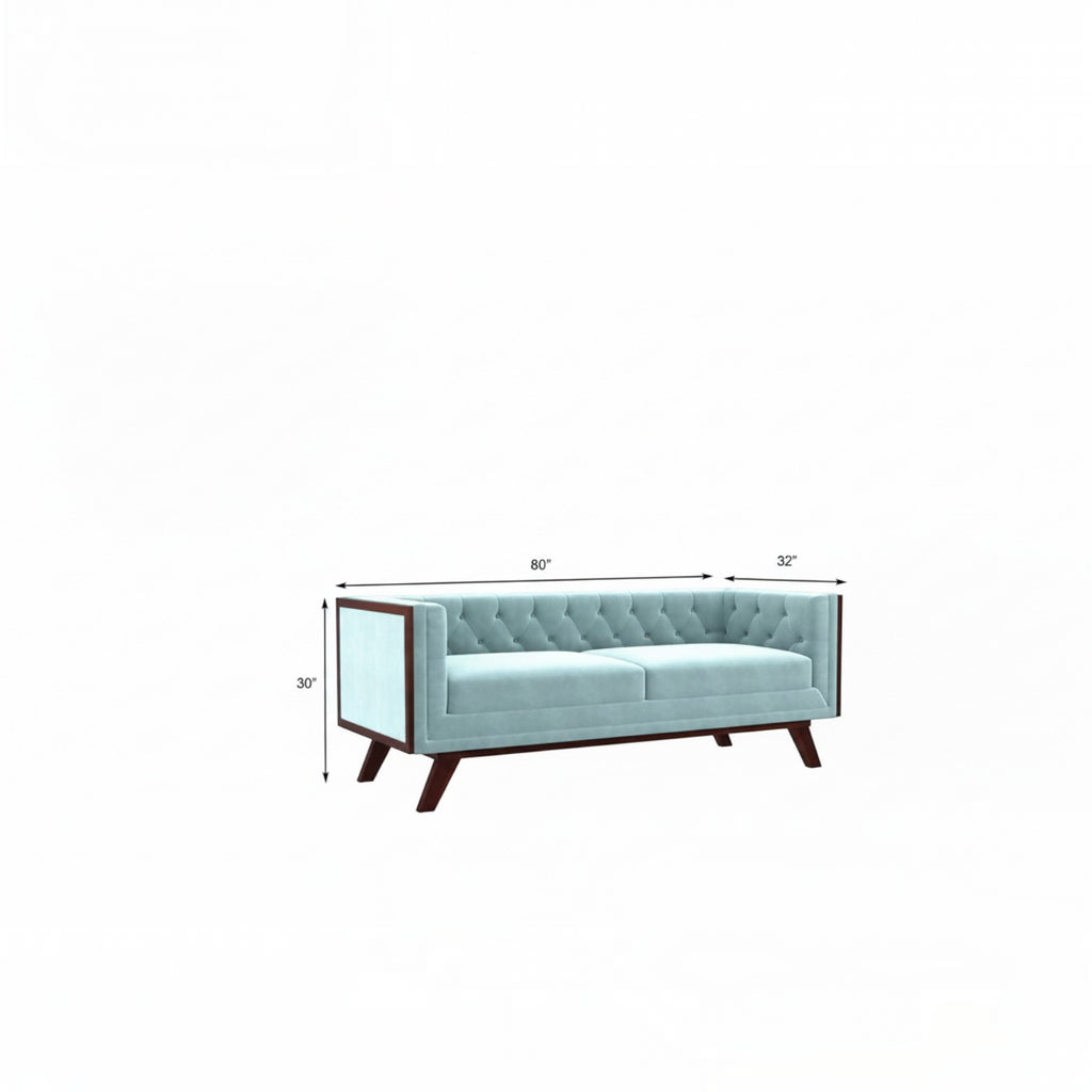 Homecrest Sturton Chesterfield sofa in dusk blue velvet with button tufting and dark wooden legs on a white background.