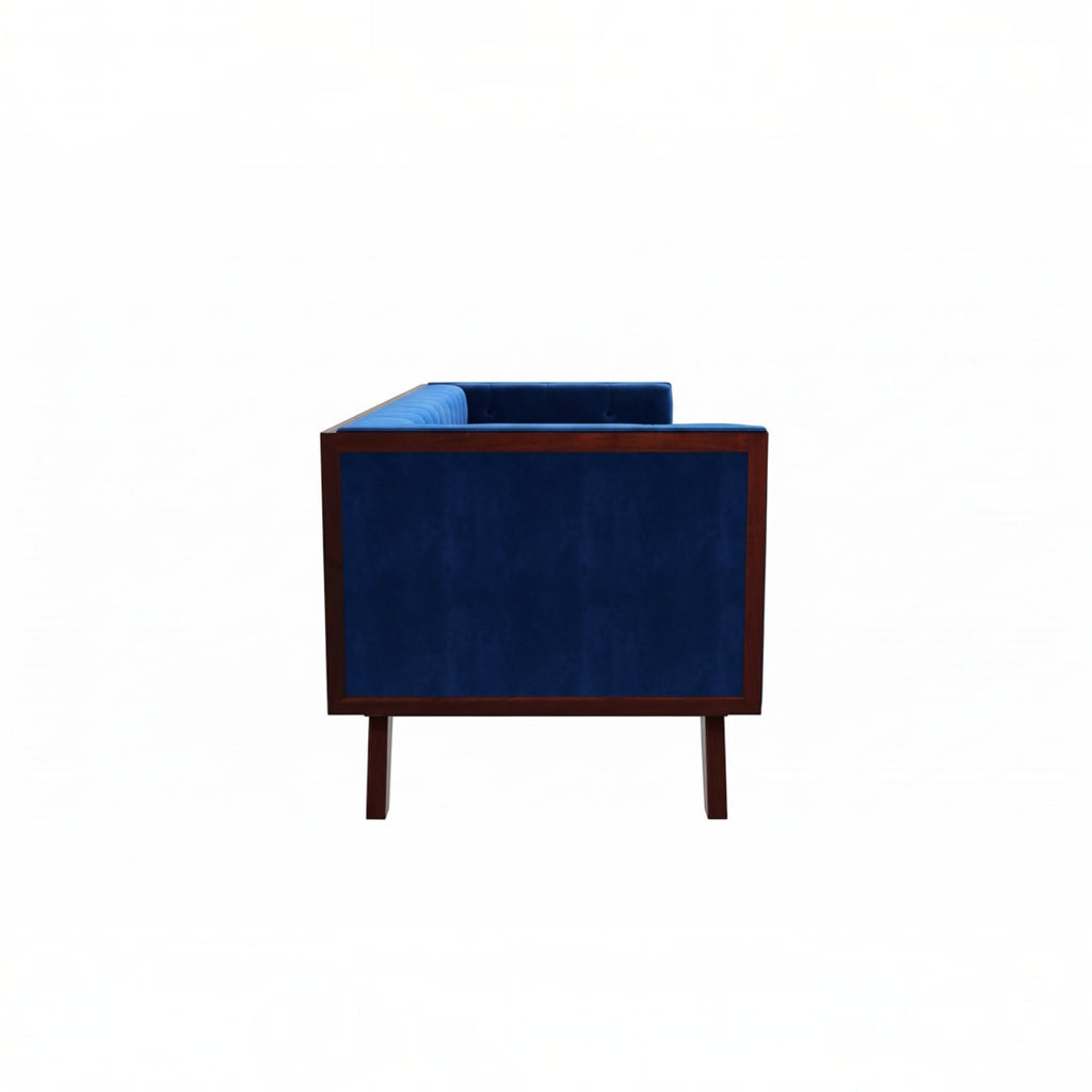 Homecrest Sturton Chesterfield sofa in deep indigo blue velvet with a dark wood frame, side view