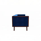 Homecrest Sturton Chesterfield sofa in deep indigo blue velvet with a dark wood frame, side view