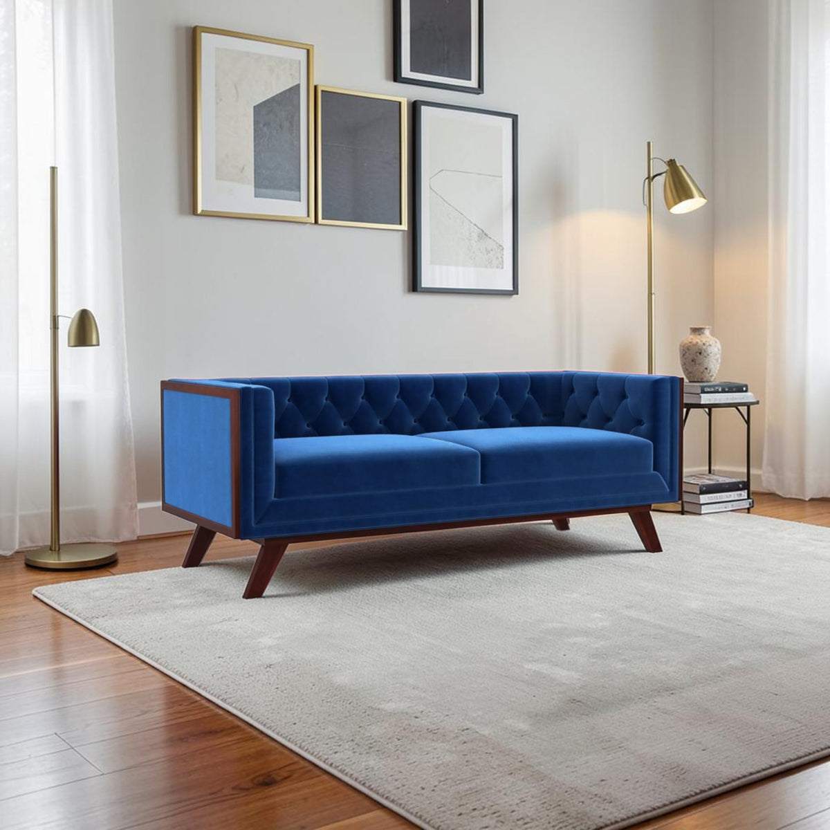 Homecrest Sturton velvet Chesterfield sofa in indigo blue with tufted backrest and dark wood frame in a modern living room