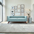 Homecrest Sturton velvet Chesterfield sofa in light blue with tufted backrest and dark wood legs in a modern living room