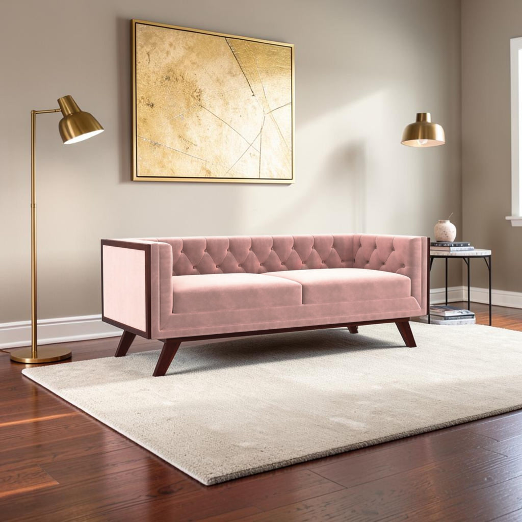 Homecrest Sturton velvet Chesterfield sofa in rose dust with button tufting and dark wooden legs in a modern living room