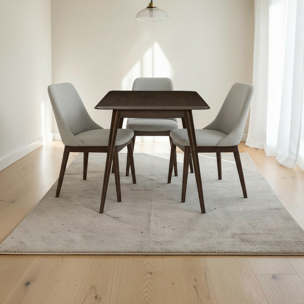 Homecrest Tarn rectangular sheesham dining table in a dark walnut finish with three grey upholstered chairs