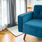 Homecrest mid-century button-down sectional sofa in teal velvet with teak wood legs in a bright living room.