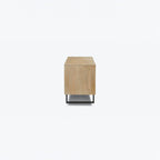Homecrest Thayer media stand in natural mango wood with rattan detailing and black metal base, side view.