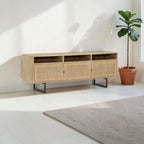 Homecrest Thayer media stand in natural mango wood with rattan door detailing and black metal legs
