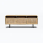 Homecrest Thayer media stand in natural mango wood with rattan cabinet doors and open shelving on metal legs.