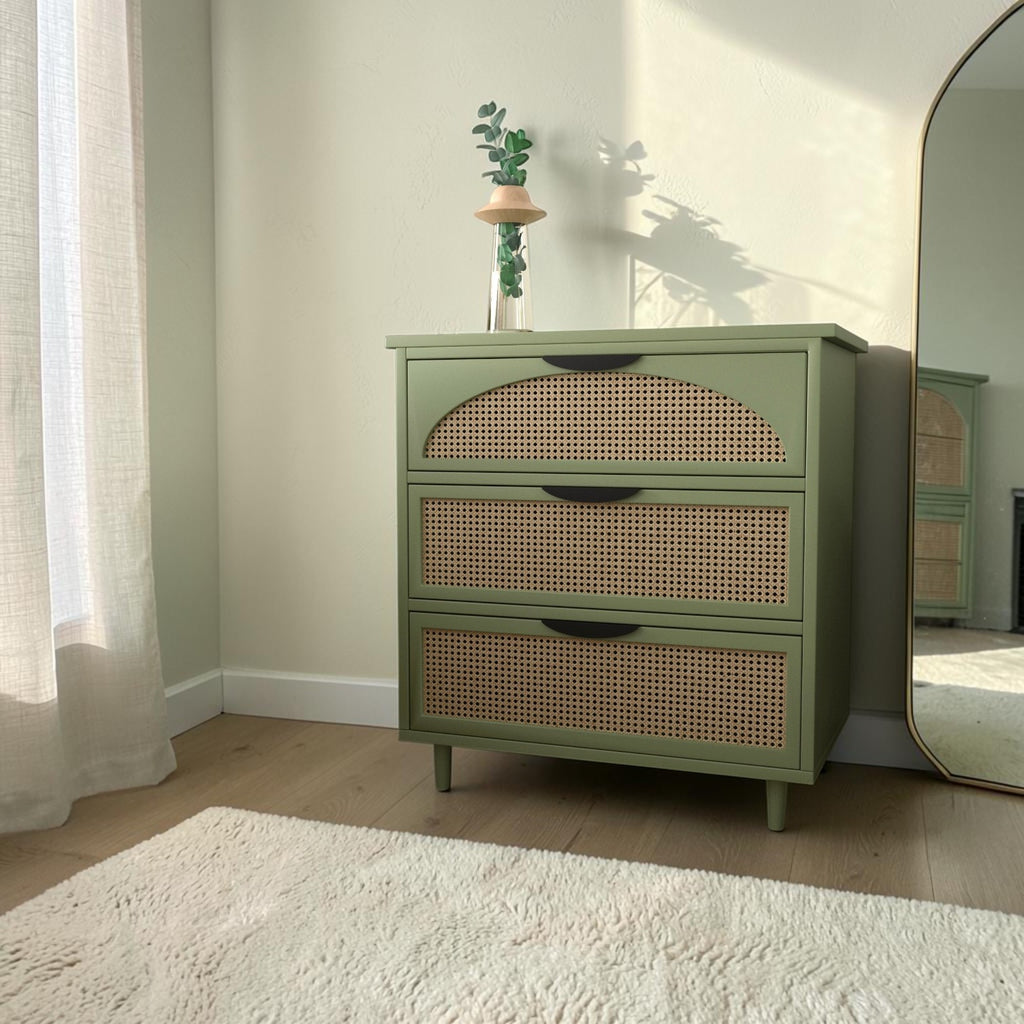 Homecrest Thea chest in Candid Green with cut-out rattan drawer fronts and tapered legs in a bright bedroom setting.