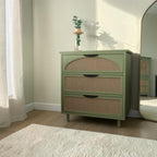 Homecrest Thea chest in Candid Green with cut-out rattan drawer fronts and tapered legs in a bright bedroom setting.