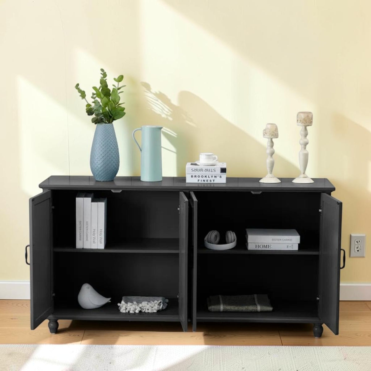 Homecrest Thorne black solid sheesham wood four-door sideboard with open cabinet storage against a pale yellow wall