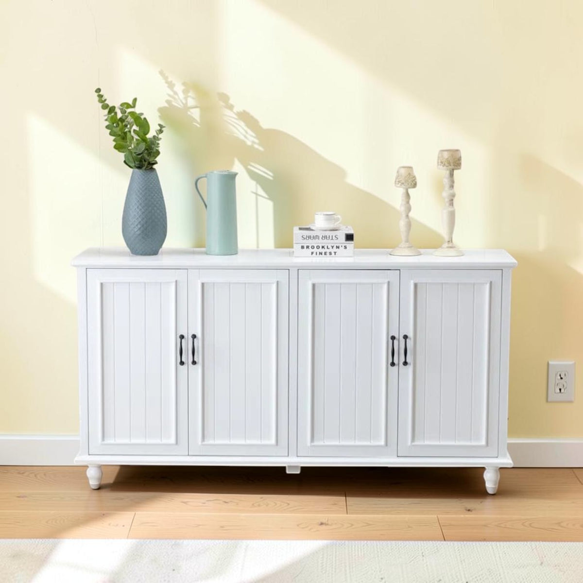Homecrest Thorne four-door white sideboard made of solid wood with vertical paneling and black hardware
