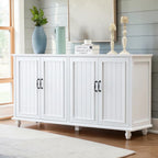 Homecrest Thorne four-door white sideboard with vertical paneling and black hardware in a bright living room setting.