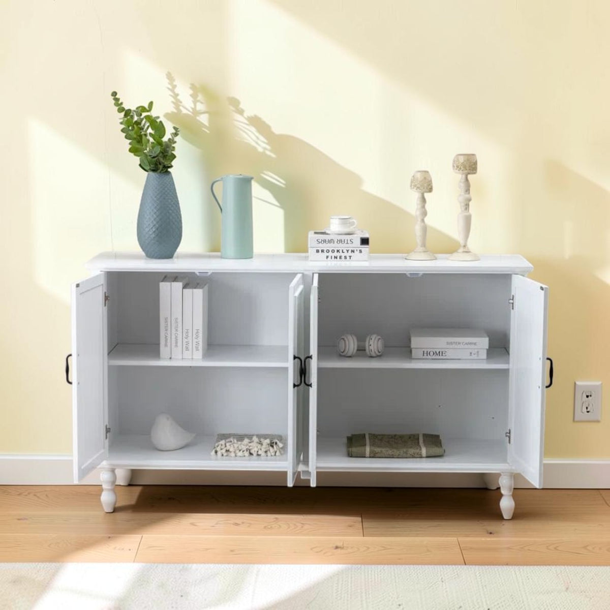 Homecrest Thorne four-door white wooden sideboard with open doors revealing internal shelving against a yellow wall