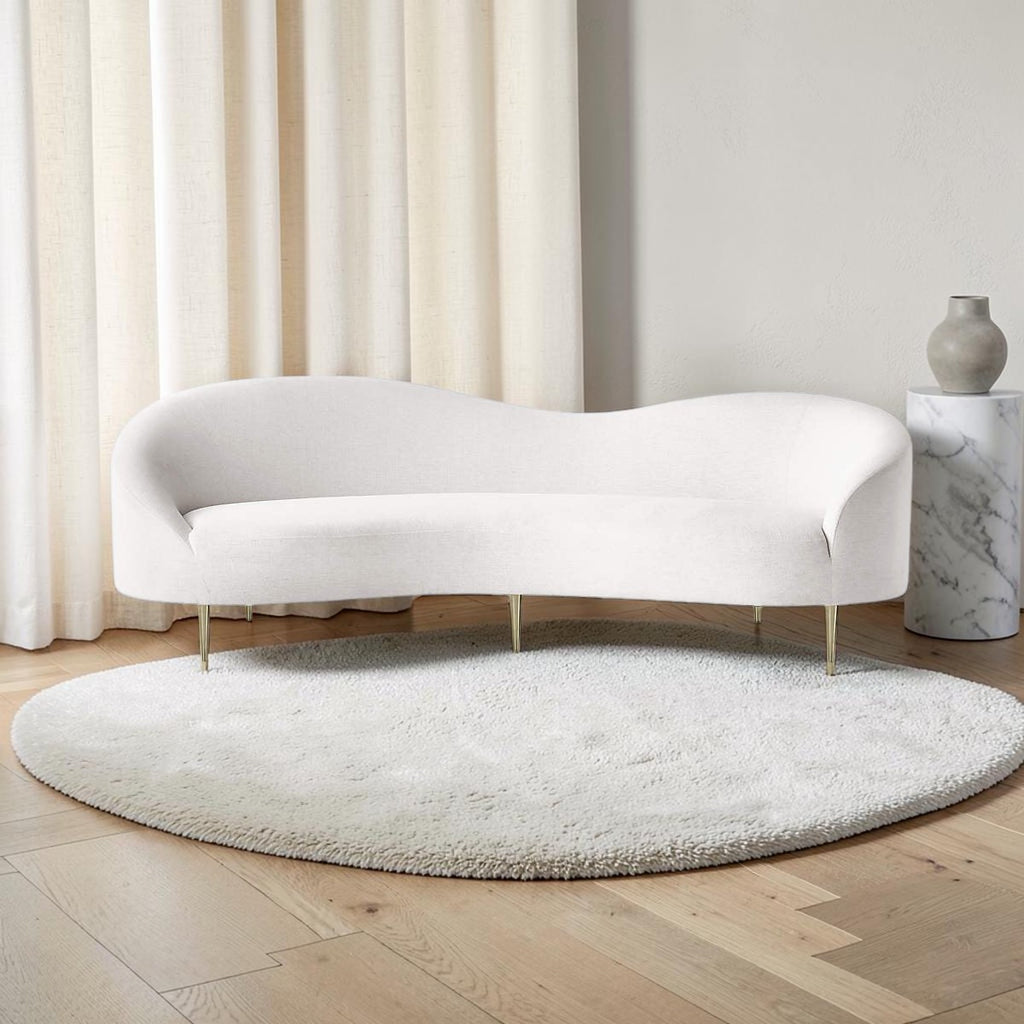 Homecrest Vernham three-seater curved sofa in white poly-linen fabric with silver metal legs on a round rug.