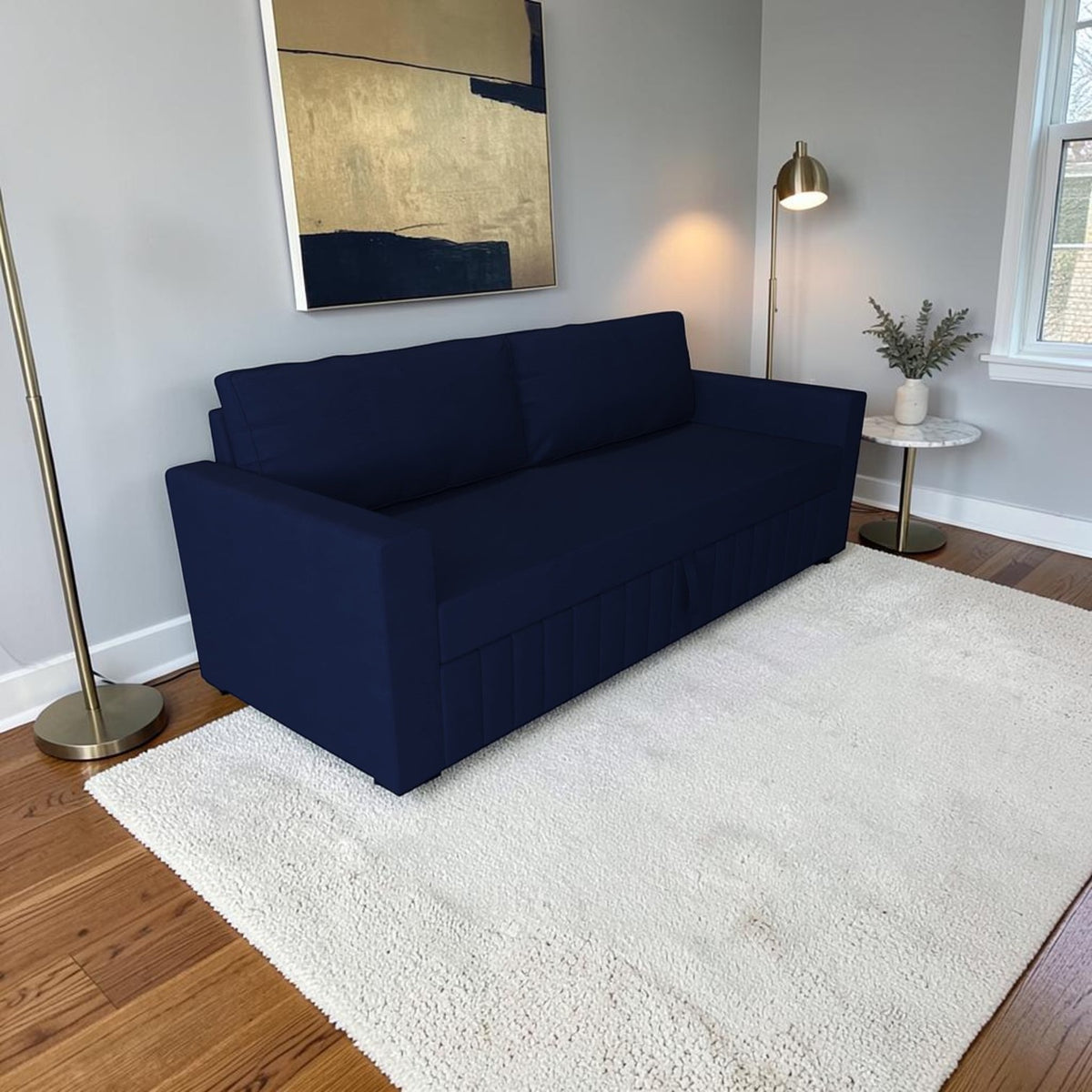 Homecrest Verity navy blue polyester three-seater sofa cum bed on a white rug in a modern living room