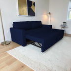 Homecrest Verity navy blue polyester sofa cum bed in a modern living room with a solid wood frame and foam cushions.