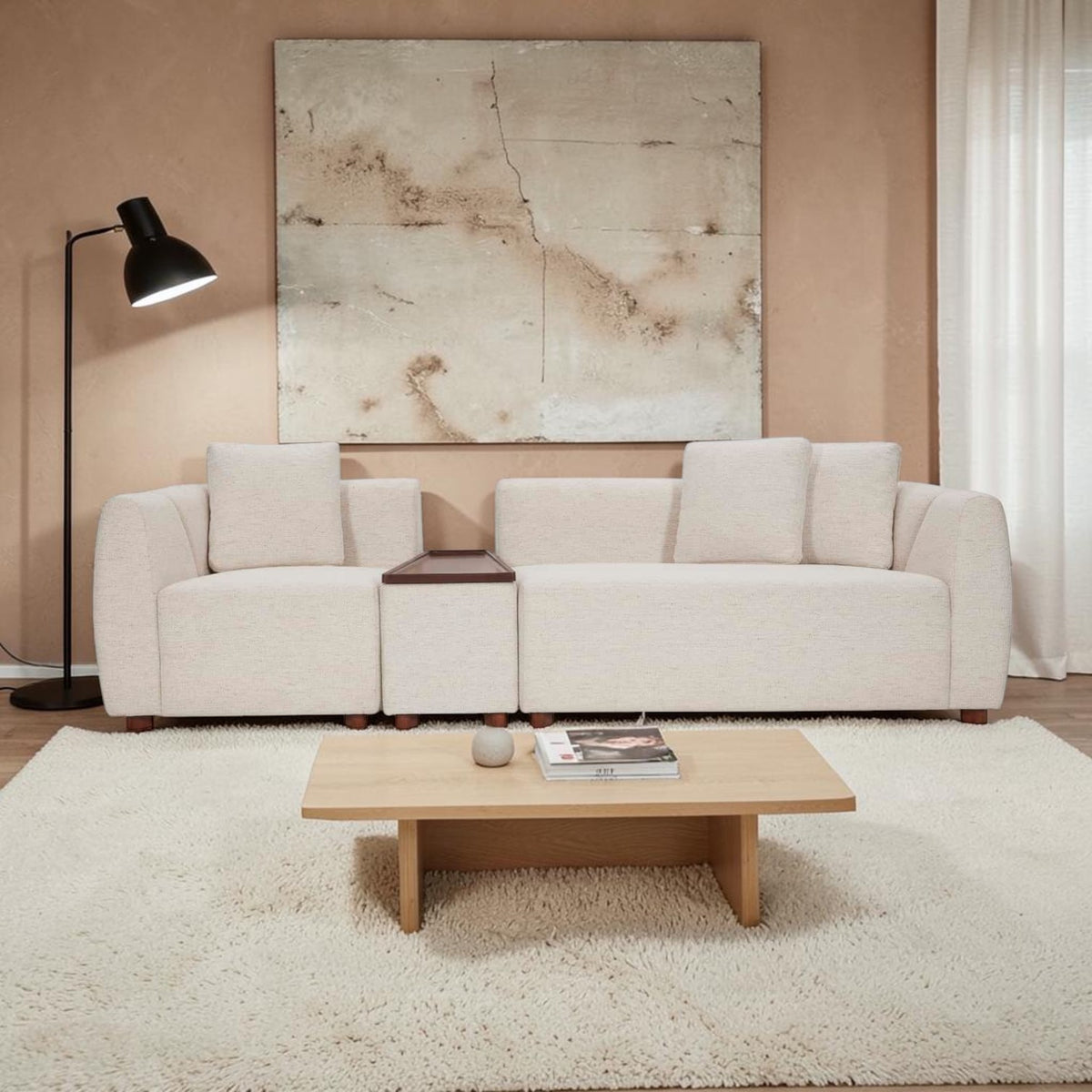 Homecrest Vero modular sofa in bone fabric with teakwood tray, arranged in a straight configuration in a living room.