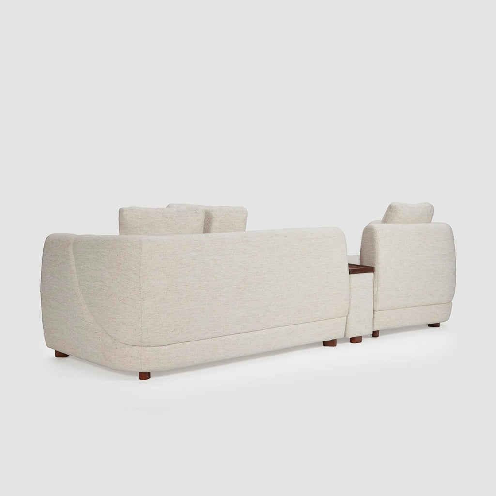 Homecrest Vero modular sofa in bone fabric with teakwood legs and integrated tray, shown from the back view.