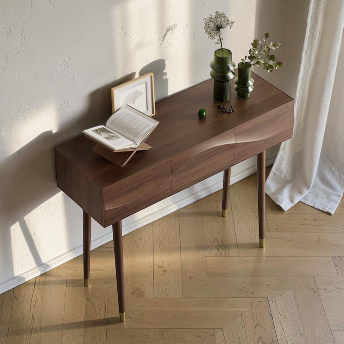 Homecrest Vessa console table in walnut-finished acacia wood with carved wave-patterned drawers and tapered legs.