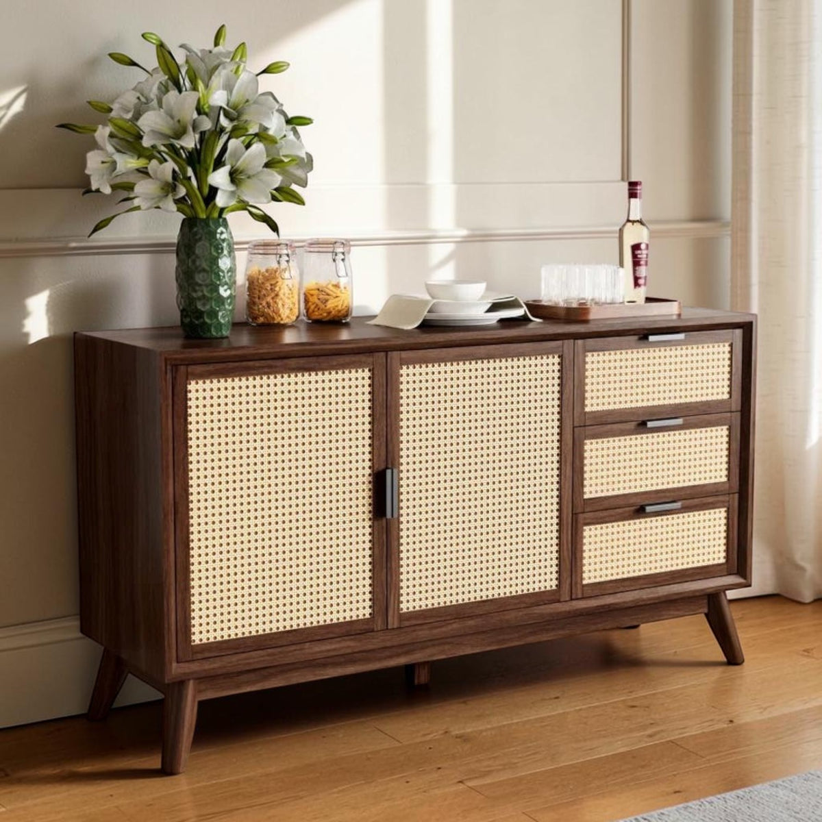 Homecrest Whitlock walnut sideboard with rattan door and drawer fronts, standing on tall tapered legs in a living room.