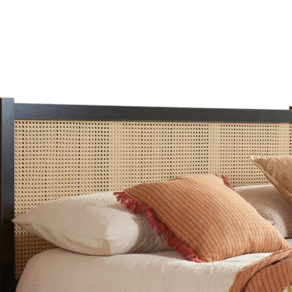 Homecrest bed featuring a black solid mango wood frame and an intricately woven natural rattan headboard.